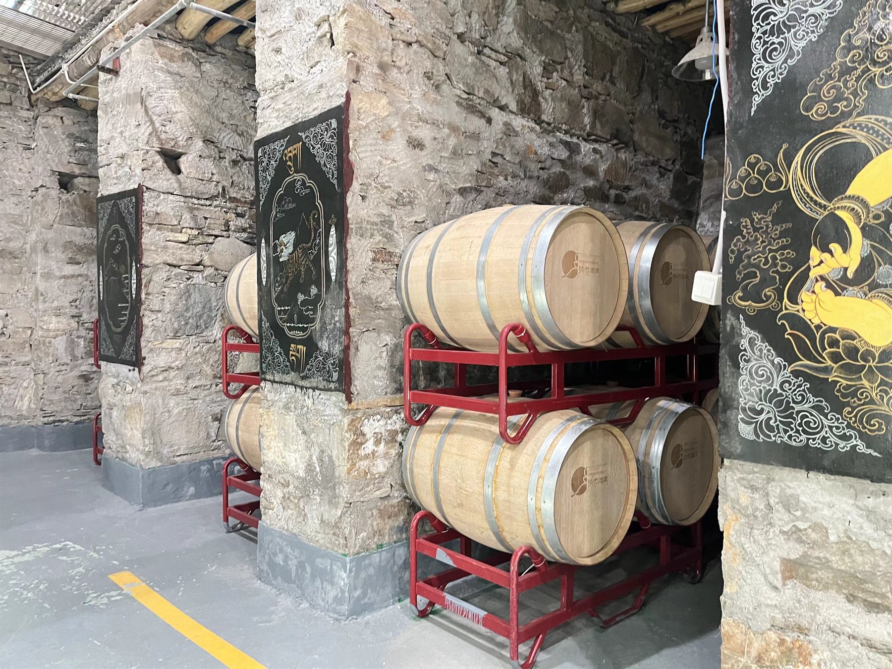 Oak barrels racked in the stone cellar